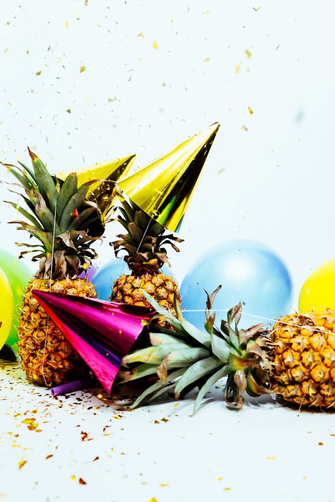 Vibrant party scene with pineapples, balloons, and confetti, perfect for celebration themes.
