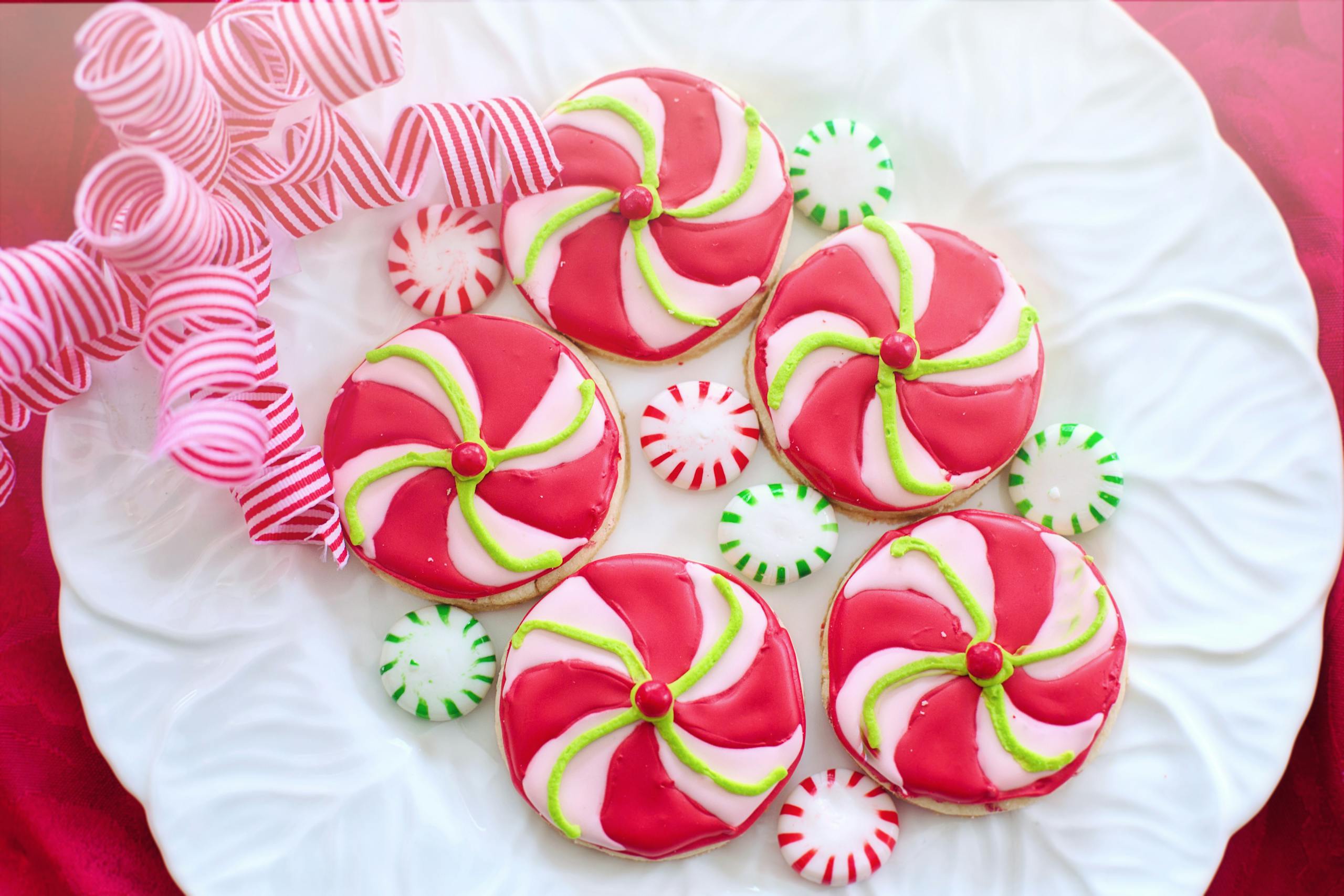 Colorful swirl peppermint cookies on a white plate for christmas