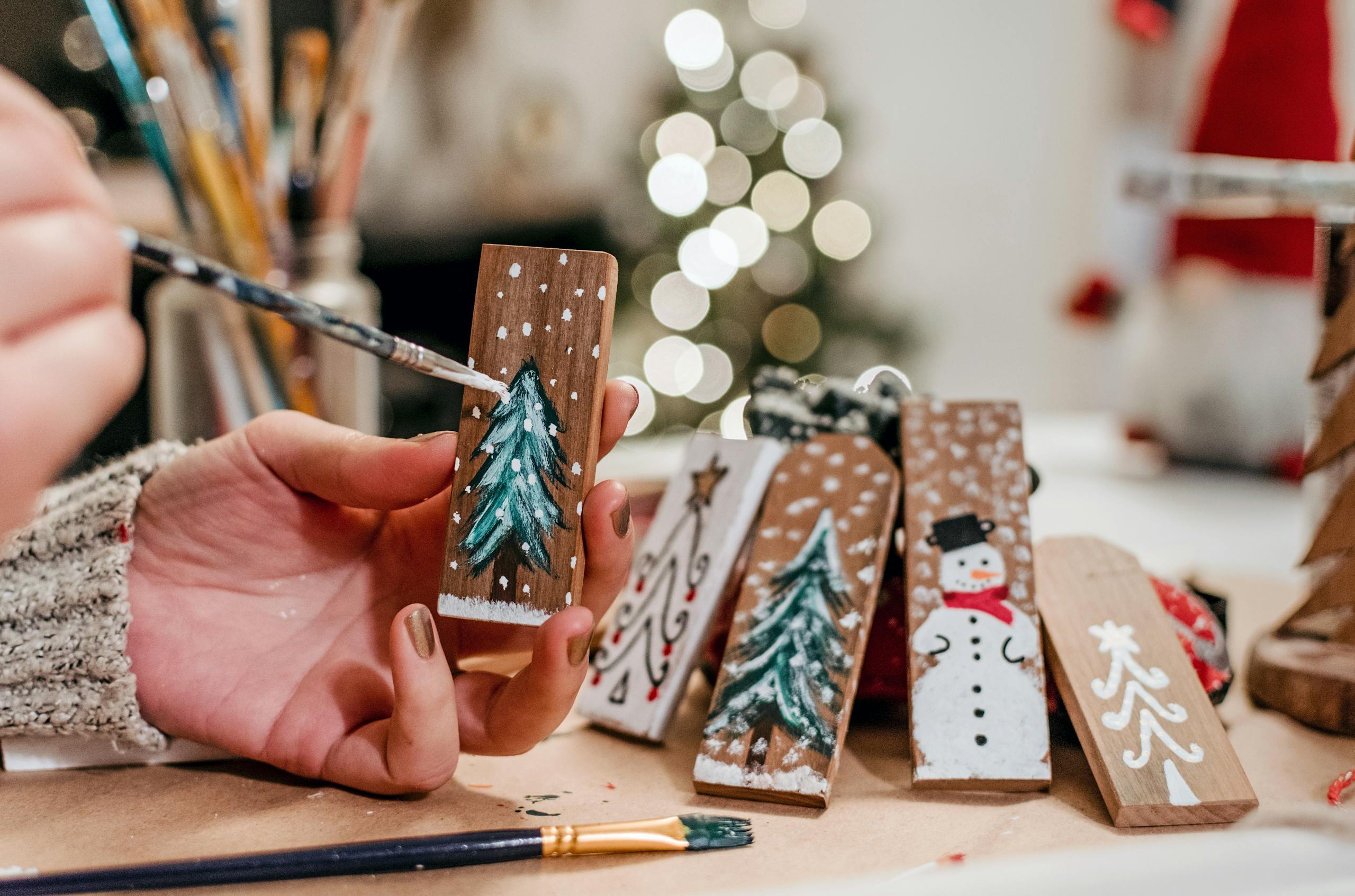 Festive Christmas crafts, painting xmas trees and snowmen with art supplies.