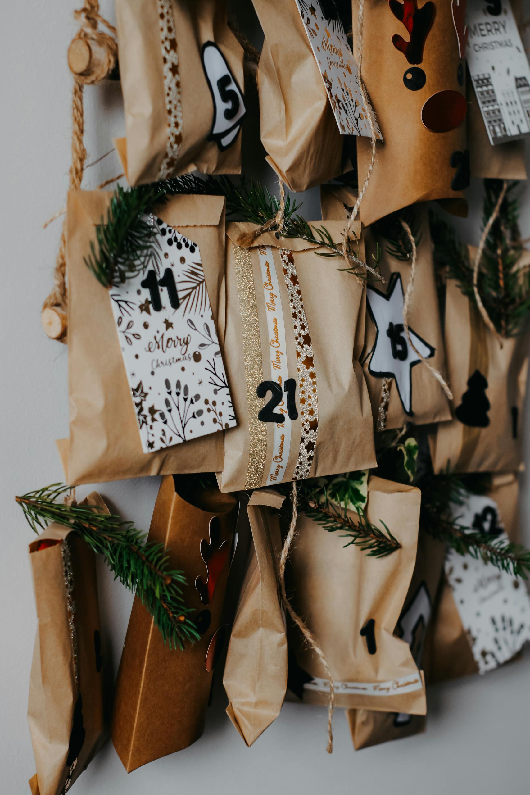 Homemade non candy christmas advent calendar kids will love made from brown paper bags festively decorated with ribbons and pine leaves.