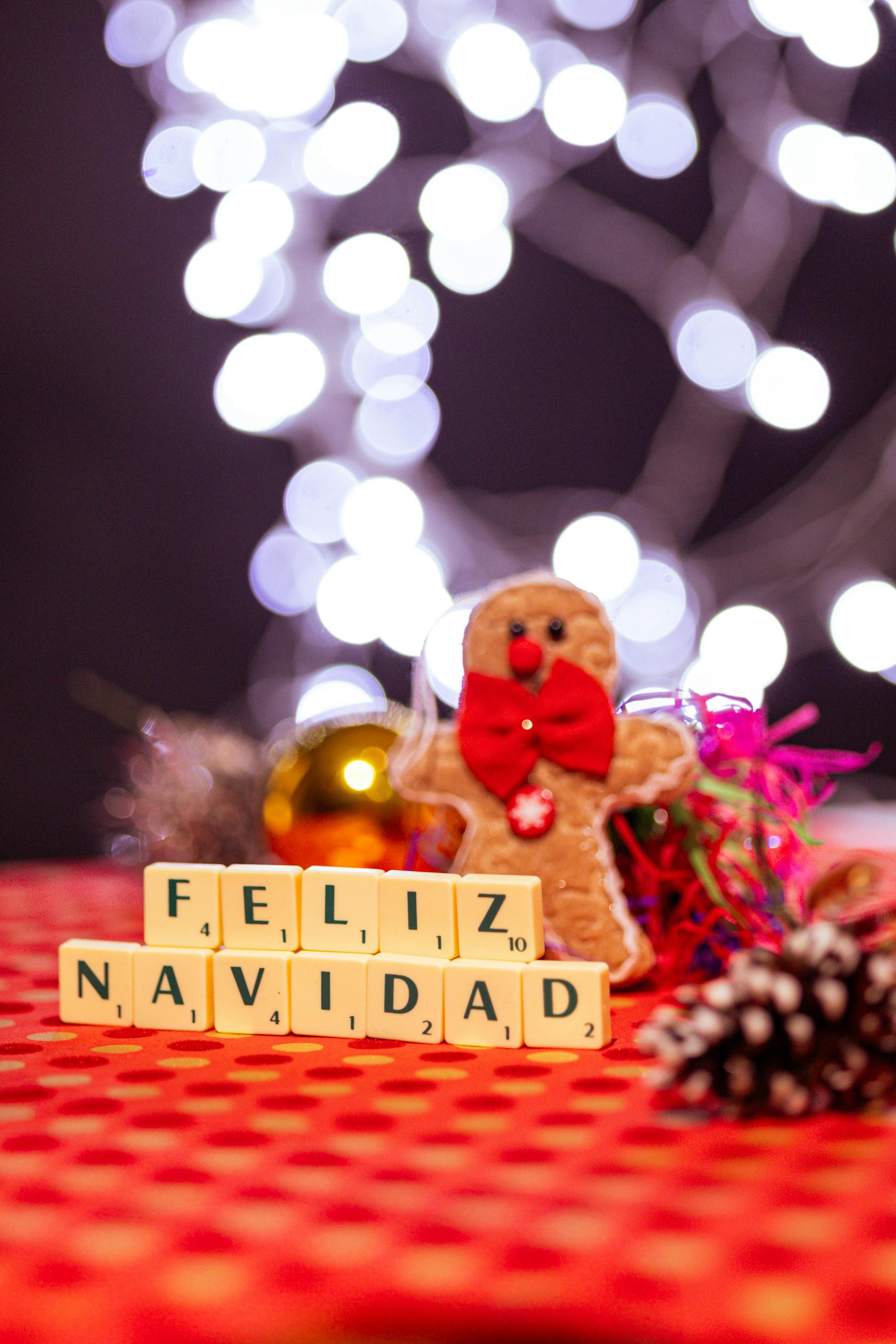 A charming Christmas scene with Feliz Navidad spelled using Scrabble tiles and festive decorations.
