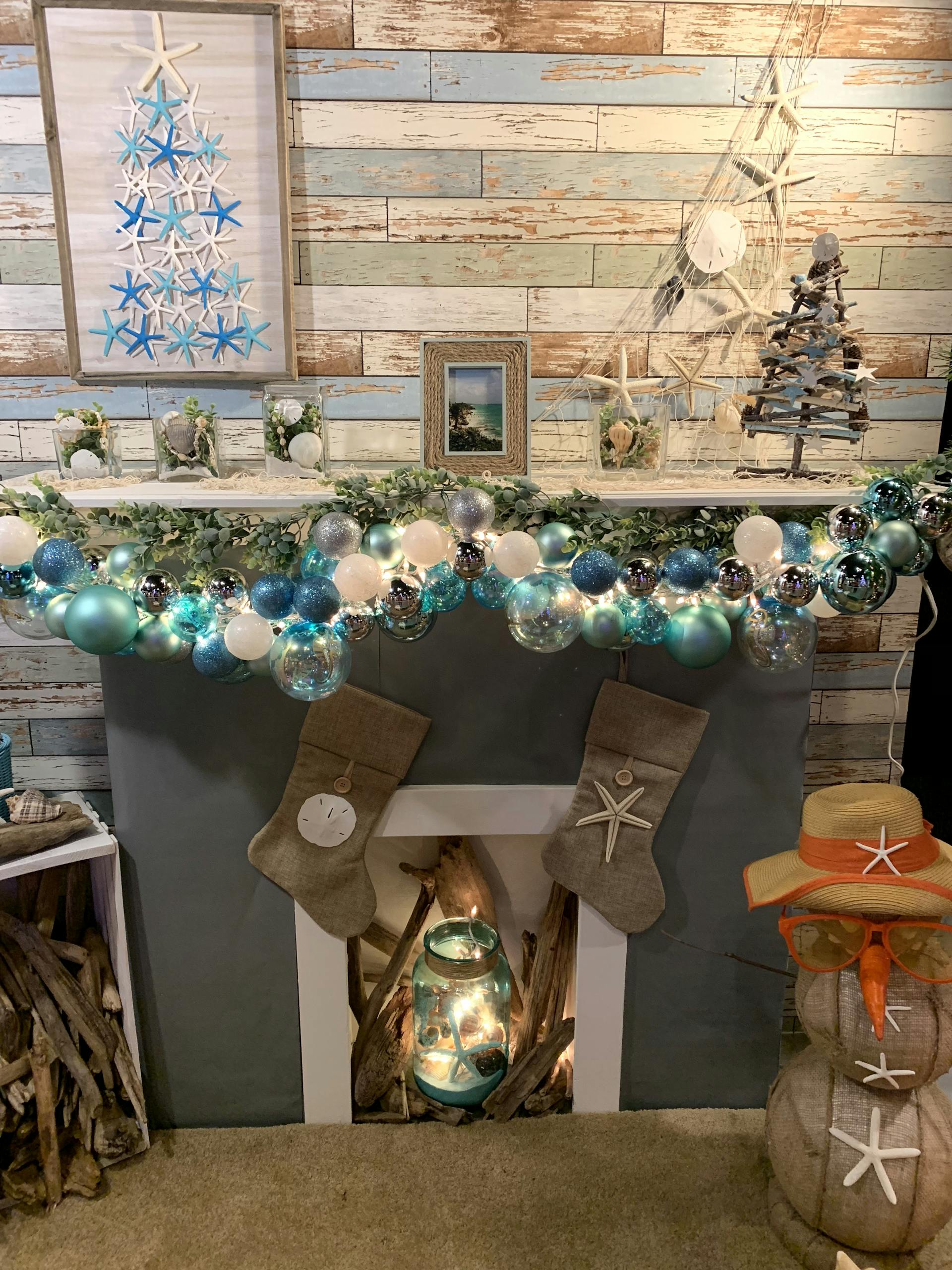 A festive coastal-themed Christmas mantel with turquoise and white ornaments.