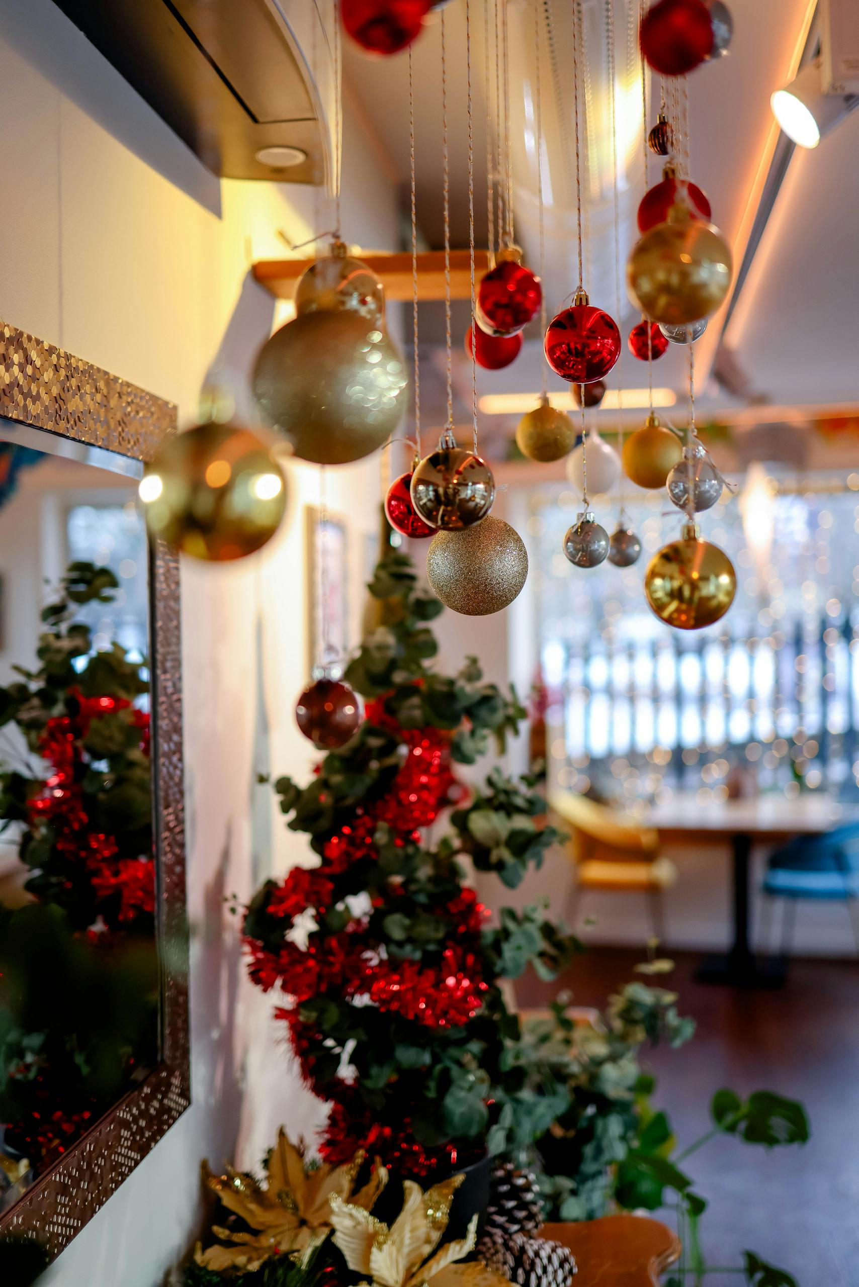 Elegant indoor Christmas decorations with ornaments and tree, creating a festive atmosphere.