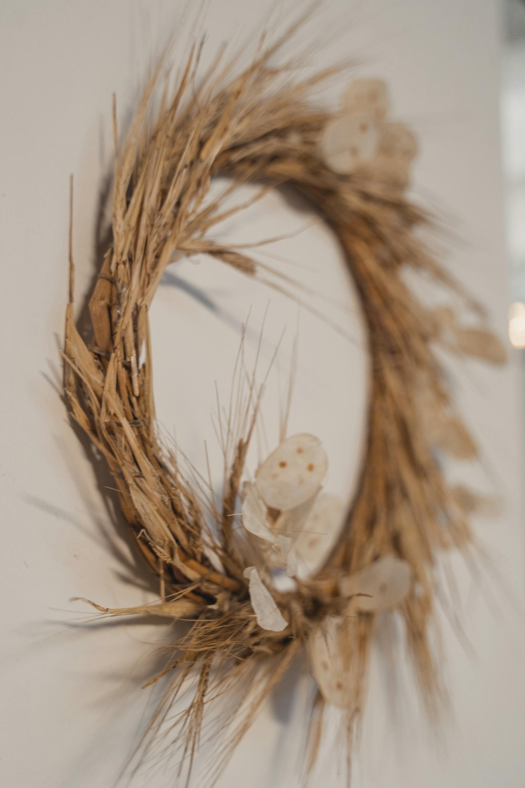 Rustic wheat and dried flower wreath adds a cozy touch to home decor.