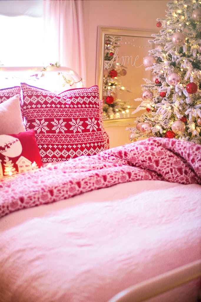 Warm and inviting bedroom with Christmas decorations and cozy bedding for a festive atmosphere.