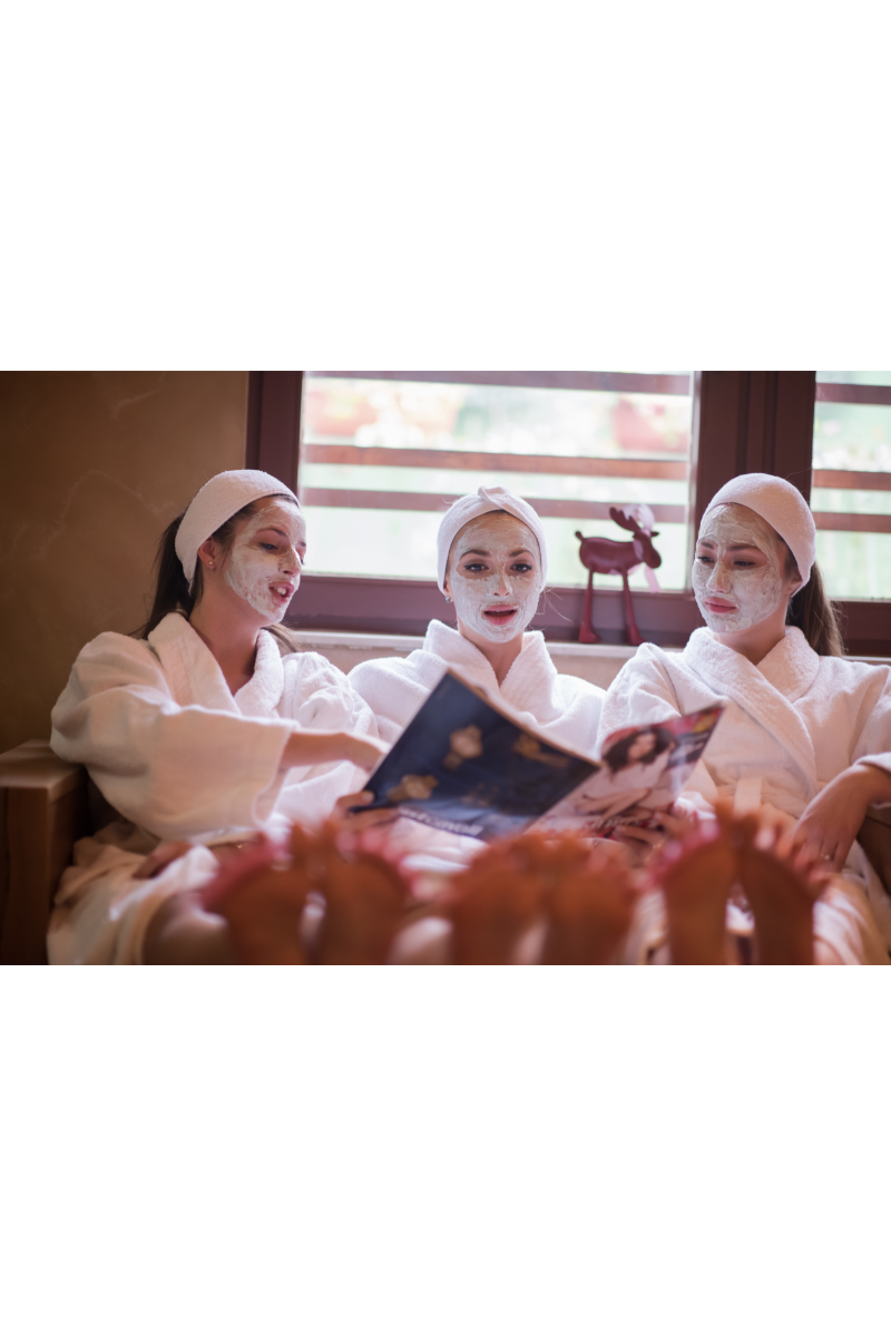 Three girl friends having a spa sleep over with natural face masks on their faces 