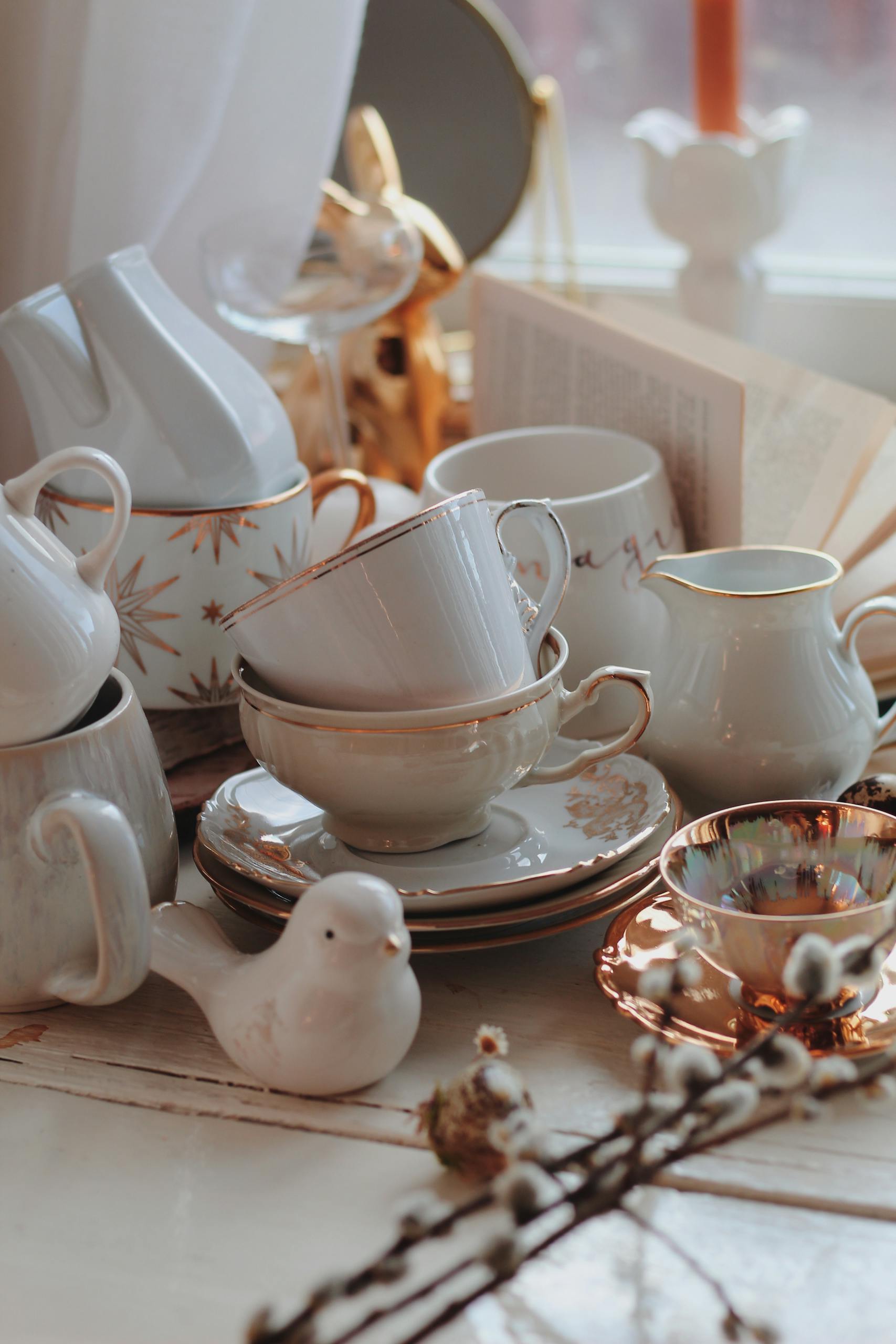 A beautifully arranged porcelain tea set with Easter-themed decor on a vintage table.
