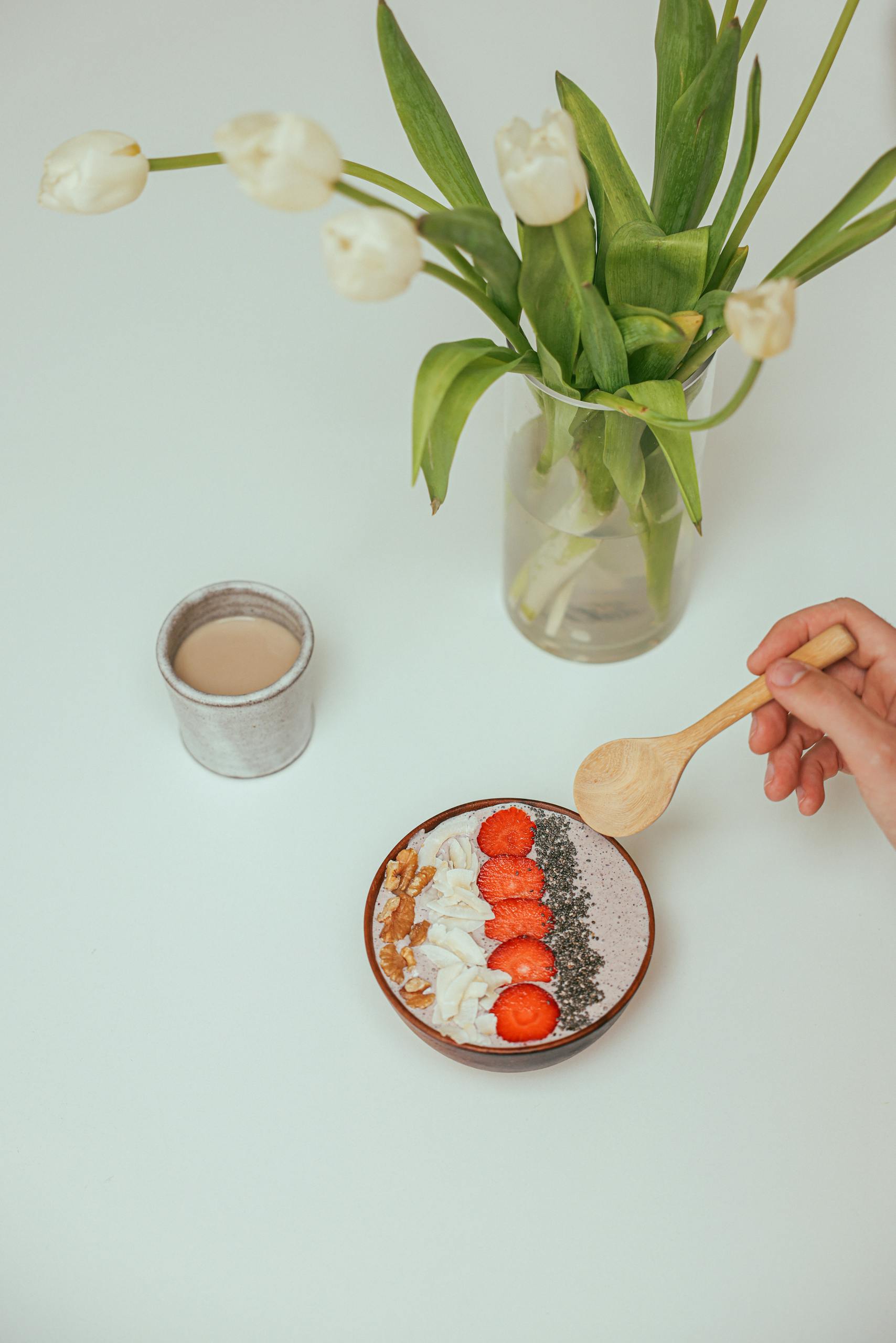 A vibrant smoothie bowl topped with fresh berries, seeds, and yogurt.