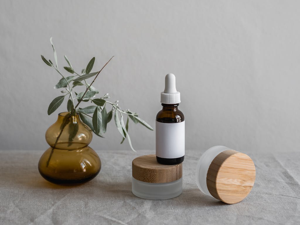 Brown glass dropper bottle with plants and minimalist decor.