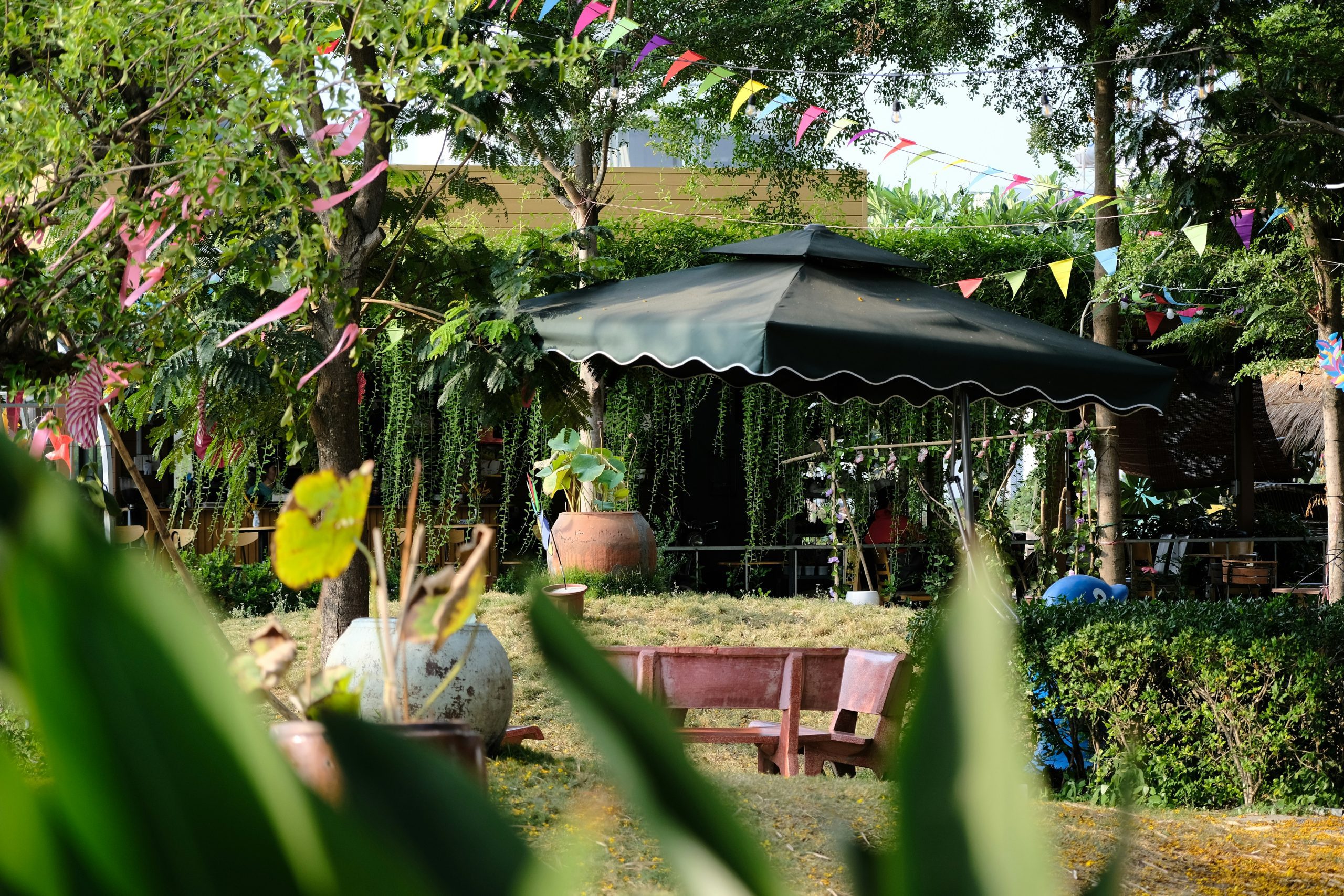 Garden party gazebo setup with weighted corners and decorations