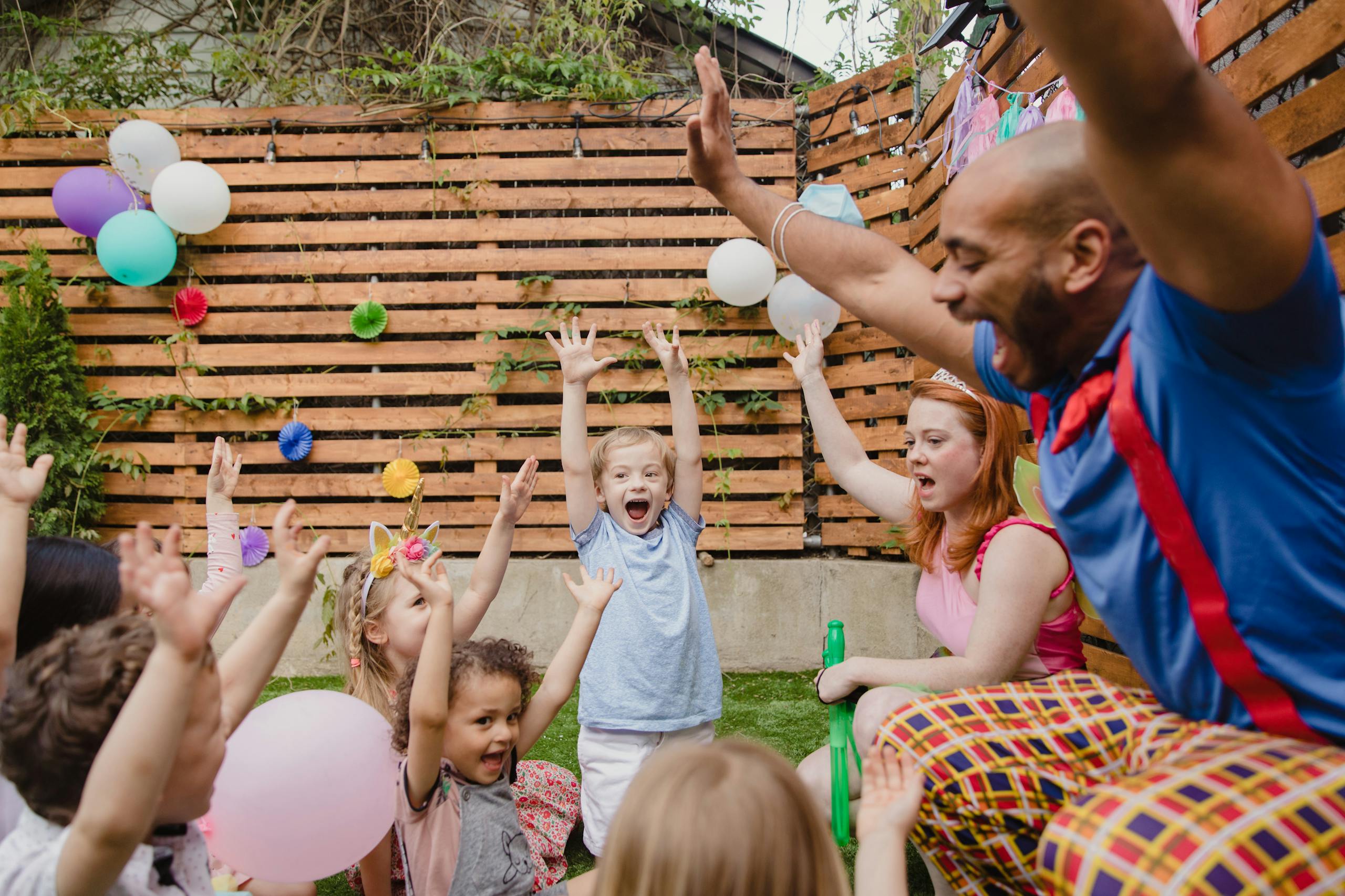 Kids and adults having fun at a lively outdoor birthday party.