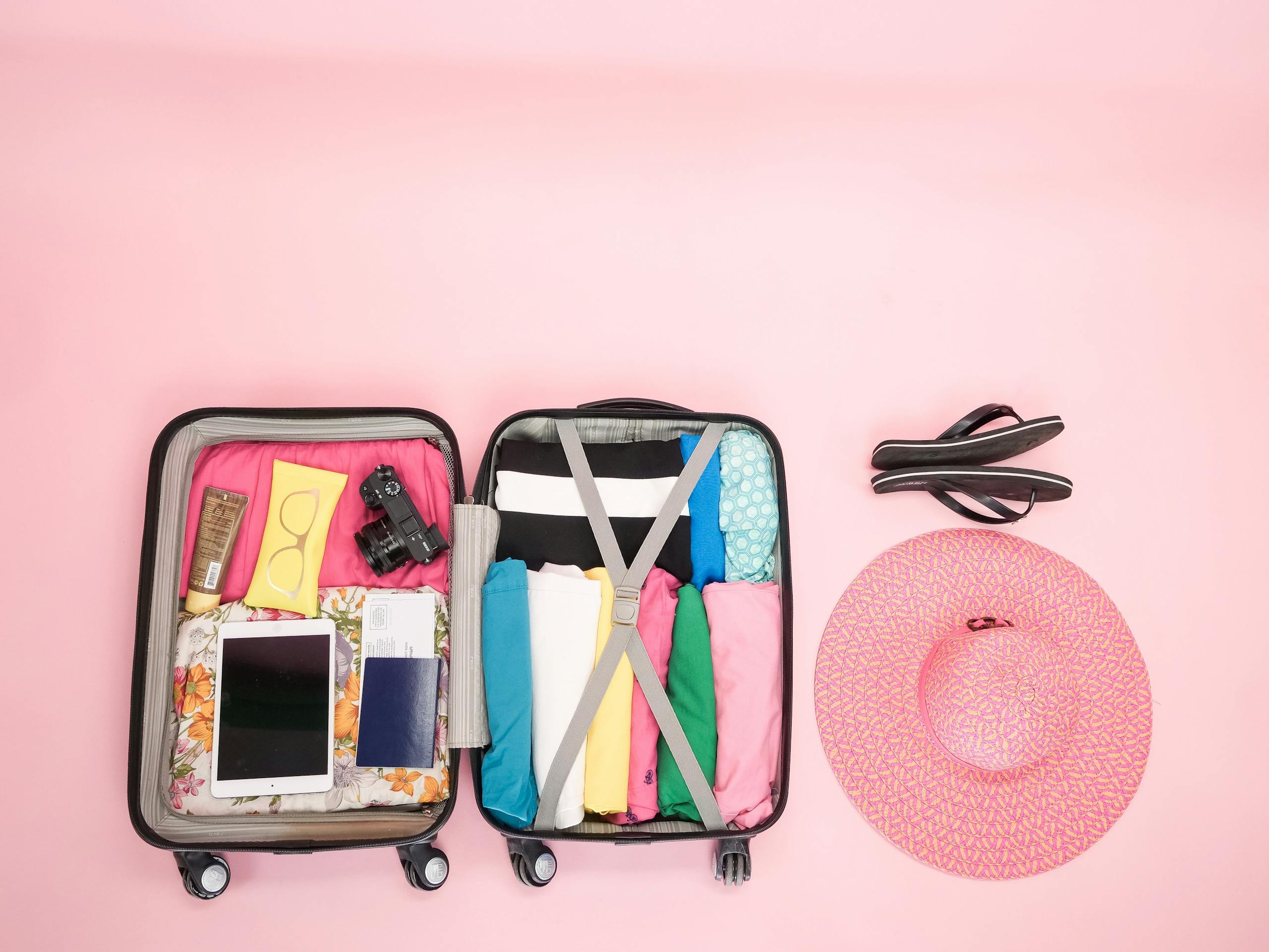 Open suitcase packed neatly with clothes and travel essentials, perfect for a summer sleepover getaway.