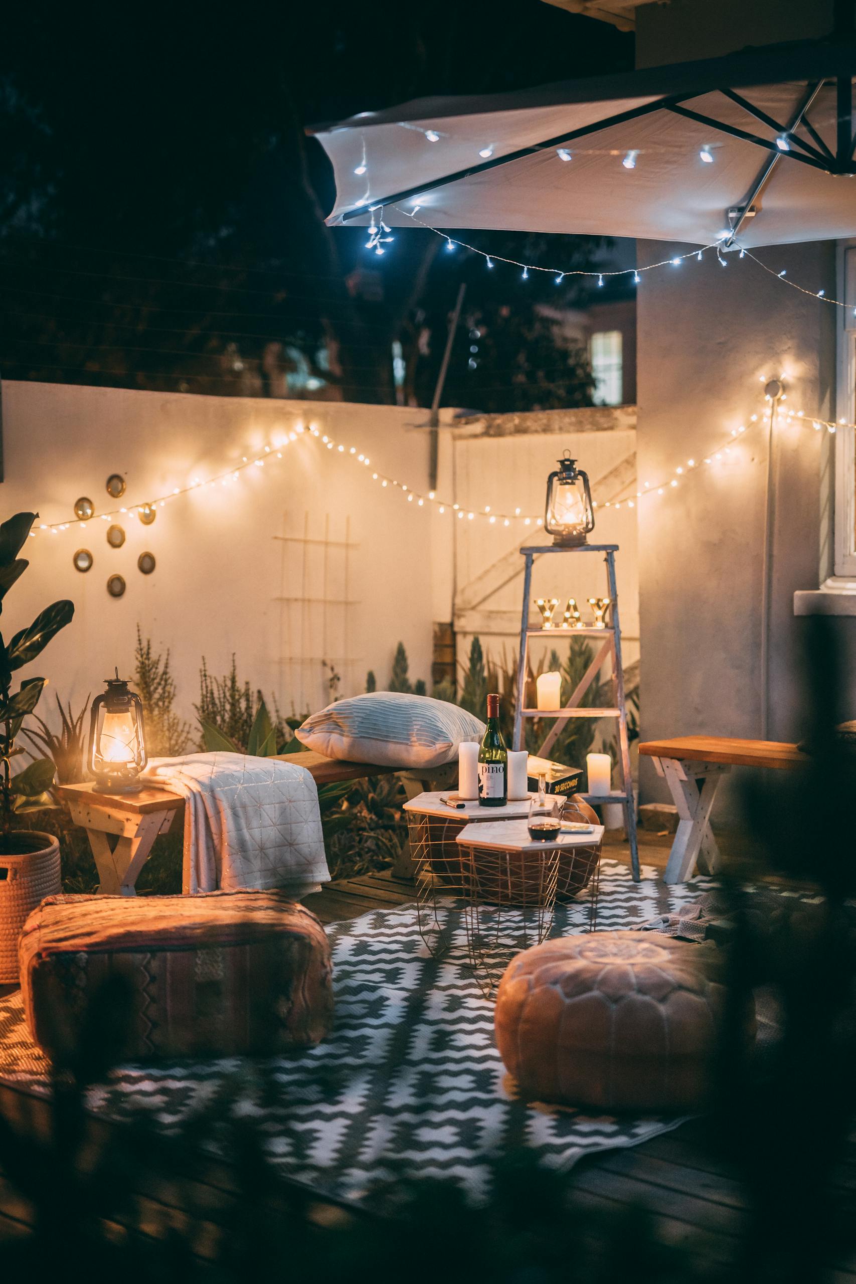 Cosy garden setup with fairy lights and cushions for spring staycation