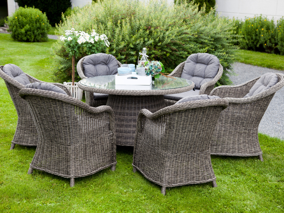 5 Grey Rattan Garden Chairs around a grey glass top round tables