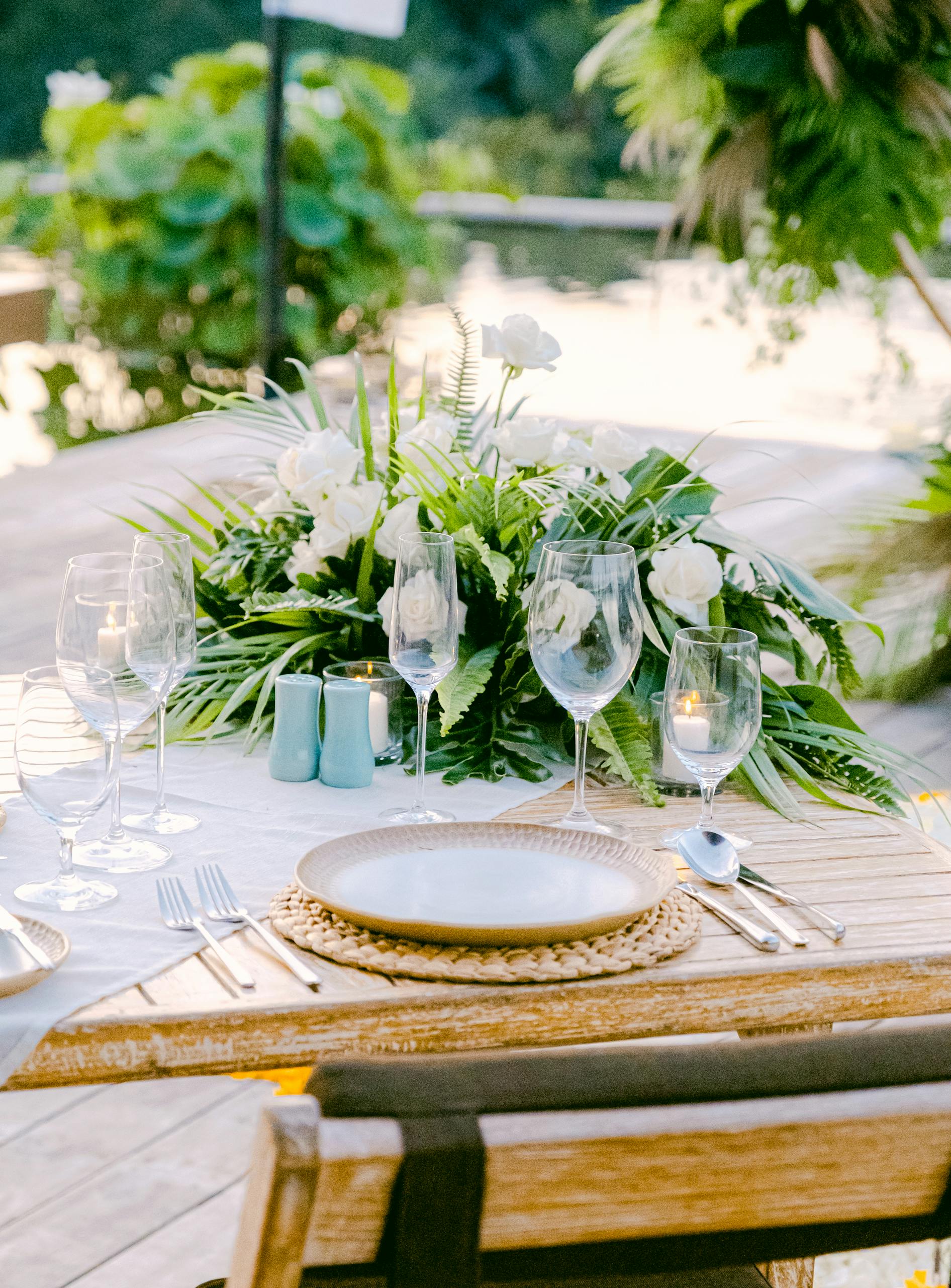 Beautifully arranged outdoor table setting with florals, perfect for a serene dining experience.