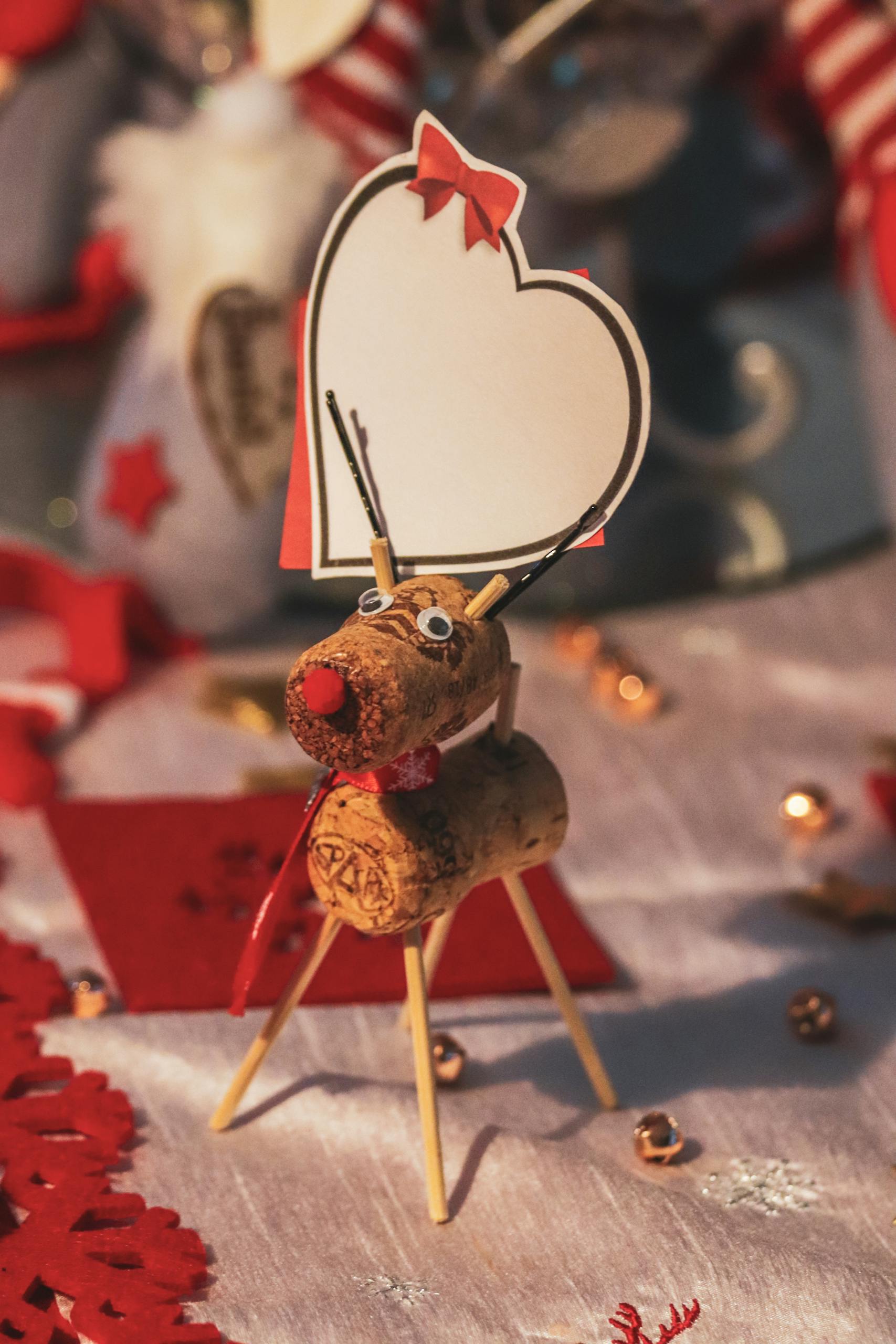 A cute handmade reindeer decoration with a heart card for festive celebrations.
