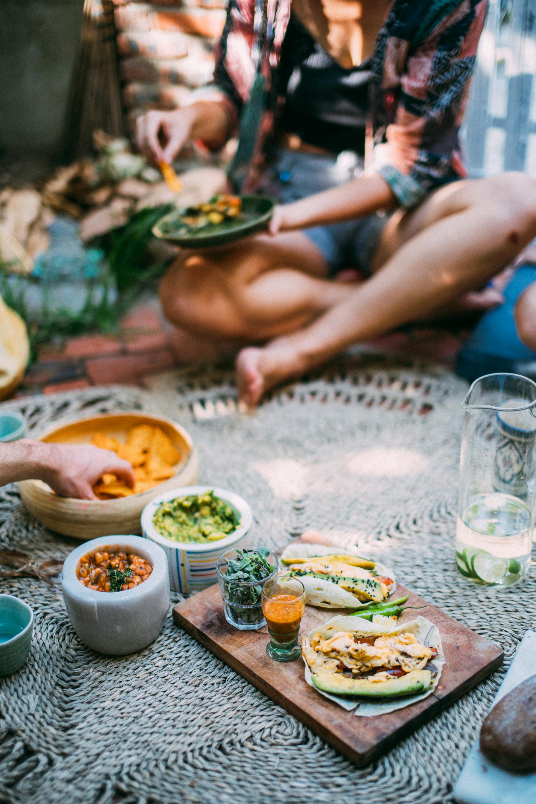 Casual outdoor picnic featuring Mexican food and relaxed atmosphere, perfect for gatherings.