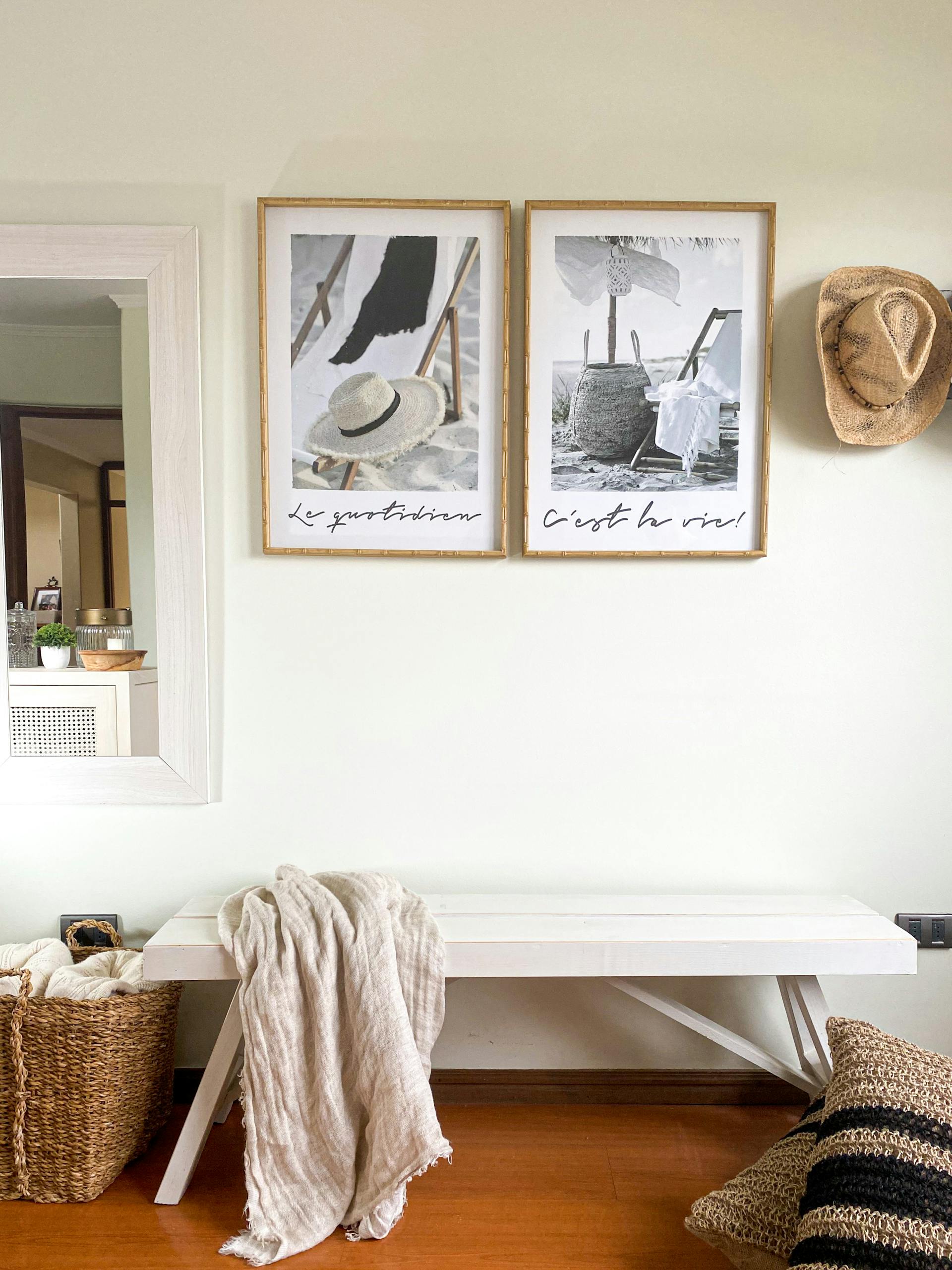 Minimalist interior design featuring a bench, wall art, and woven textures.