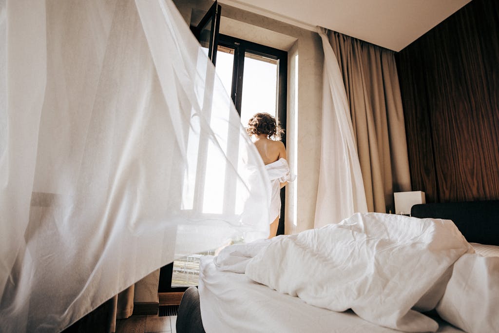 Blackout curtains closed in bedroom during summer heatwave budget bedroom cool