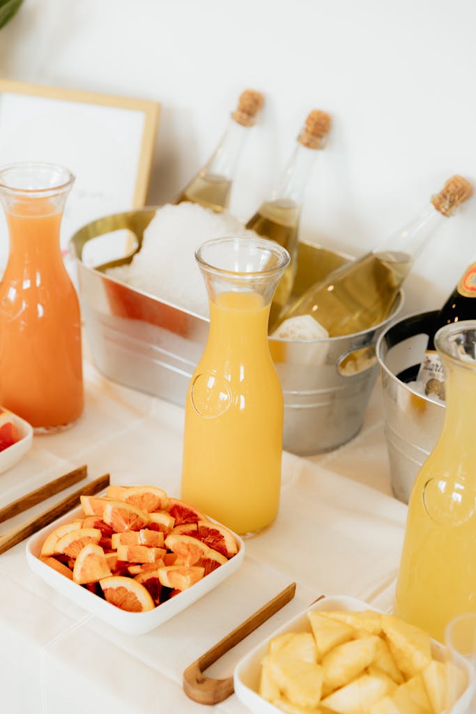 A vibrant display of juices and fruits set up for a refreshing drinks buffet station.