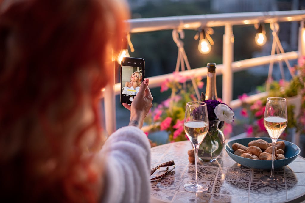 woman relaxing at home on a summer evening with fairy lights and candles for a cosy summer night in at home