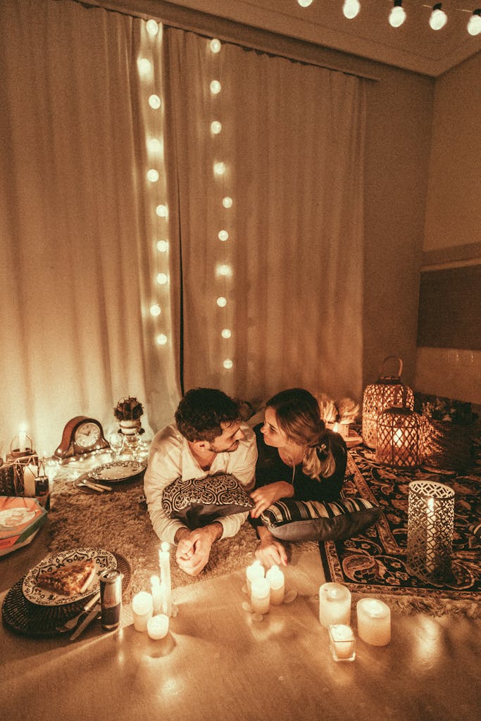 Cosy romantic setting with candles and lights creating a warm ambiance for a summer evening indoors 