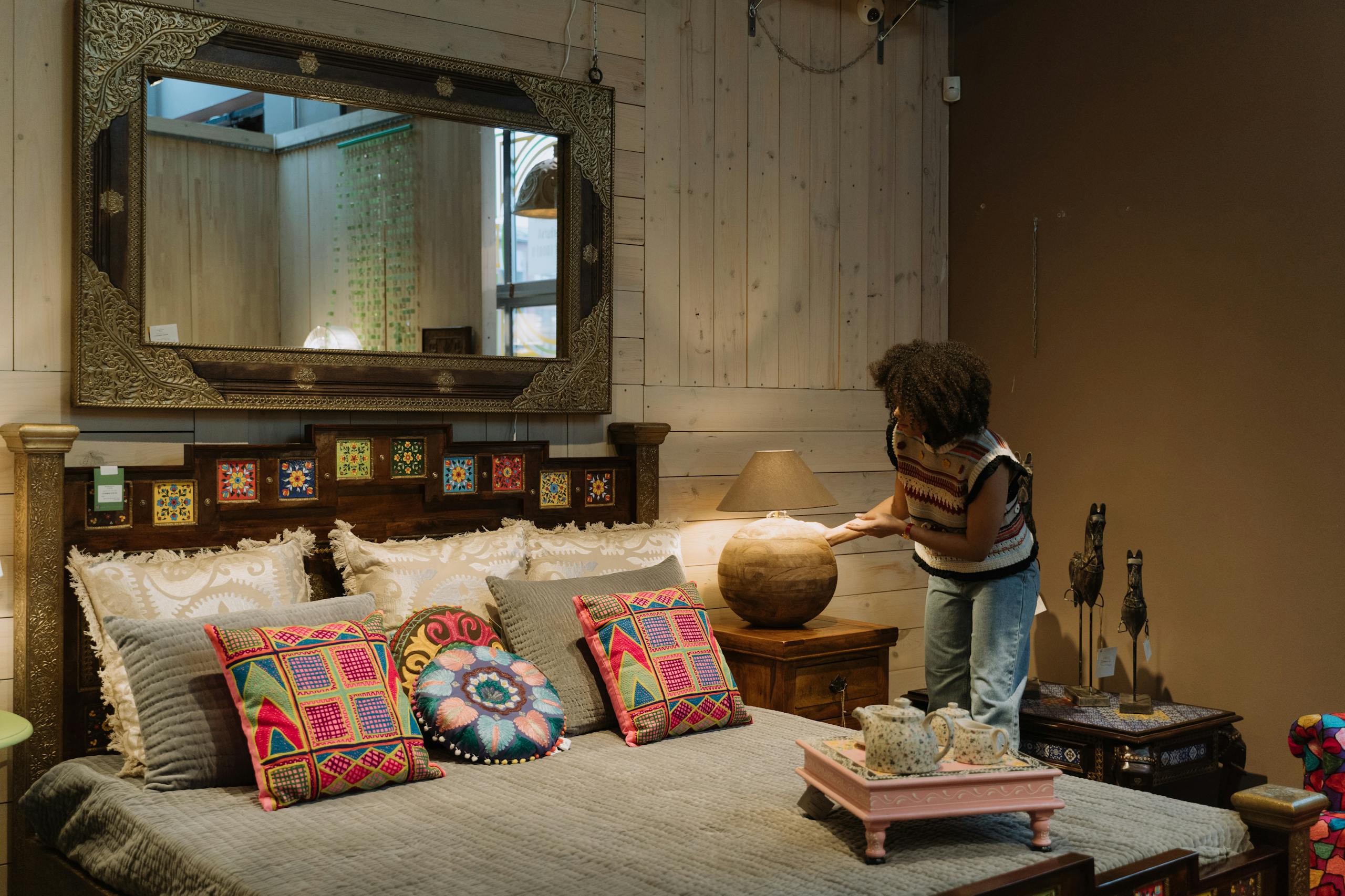 Woman redecorating room with top afrohemian colourful decor.