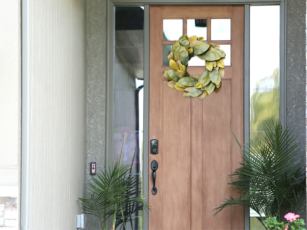 front door with seasonal wreath and potted plants — creating a welcoming home entrance that feels like a retreat