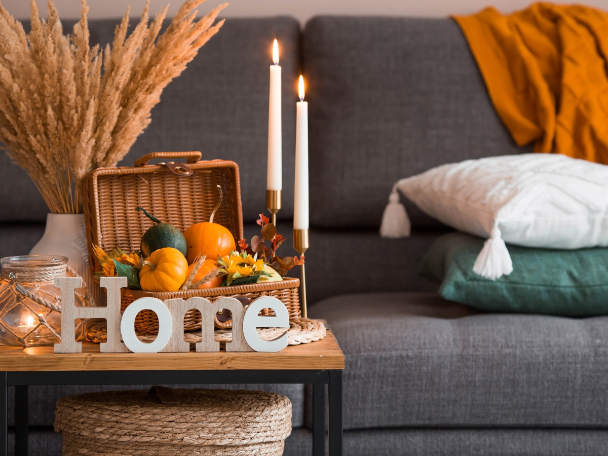 seasonal home decor with autumn leaves and candles on mantelpiece — seasonal home styling ideas for a year-round home retreat