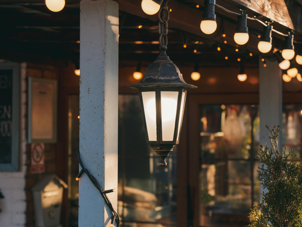 Solar festoon lights strung on front porch railing best porch makeover buys summer