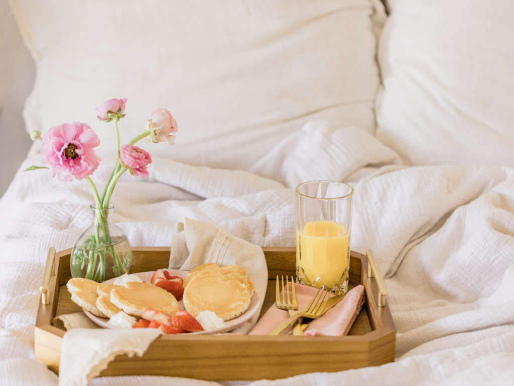 Wooden tray holding breakfast for a hotel inspired morning routine.