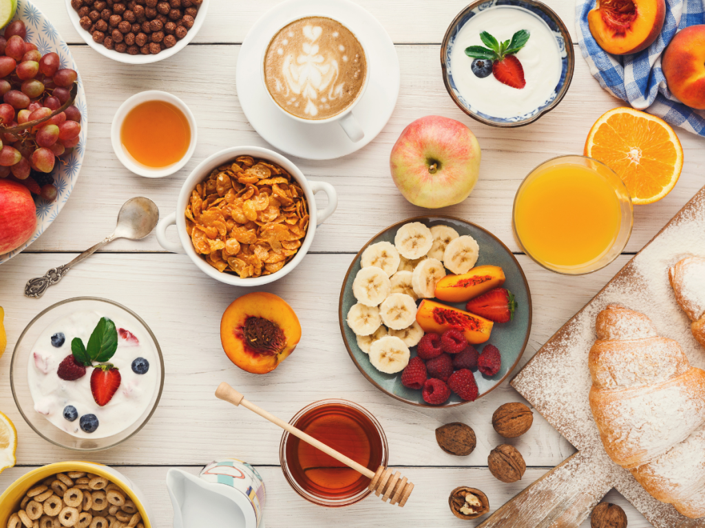 : Hotel style continental breakfast spread at home with pastries fruit and fresh orange juice