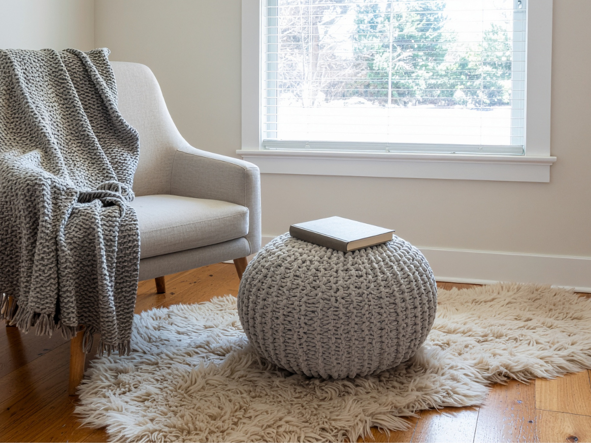 Cosy reading corner with armchair, floor lamp and small side table in a partially unpacked new home — moving hacks to make your new home feel like a dream getaway