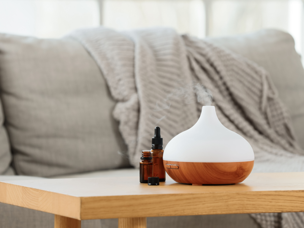 essential oil diffuser misting in a living room for a cosy home staycation retreat