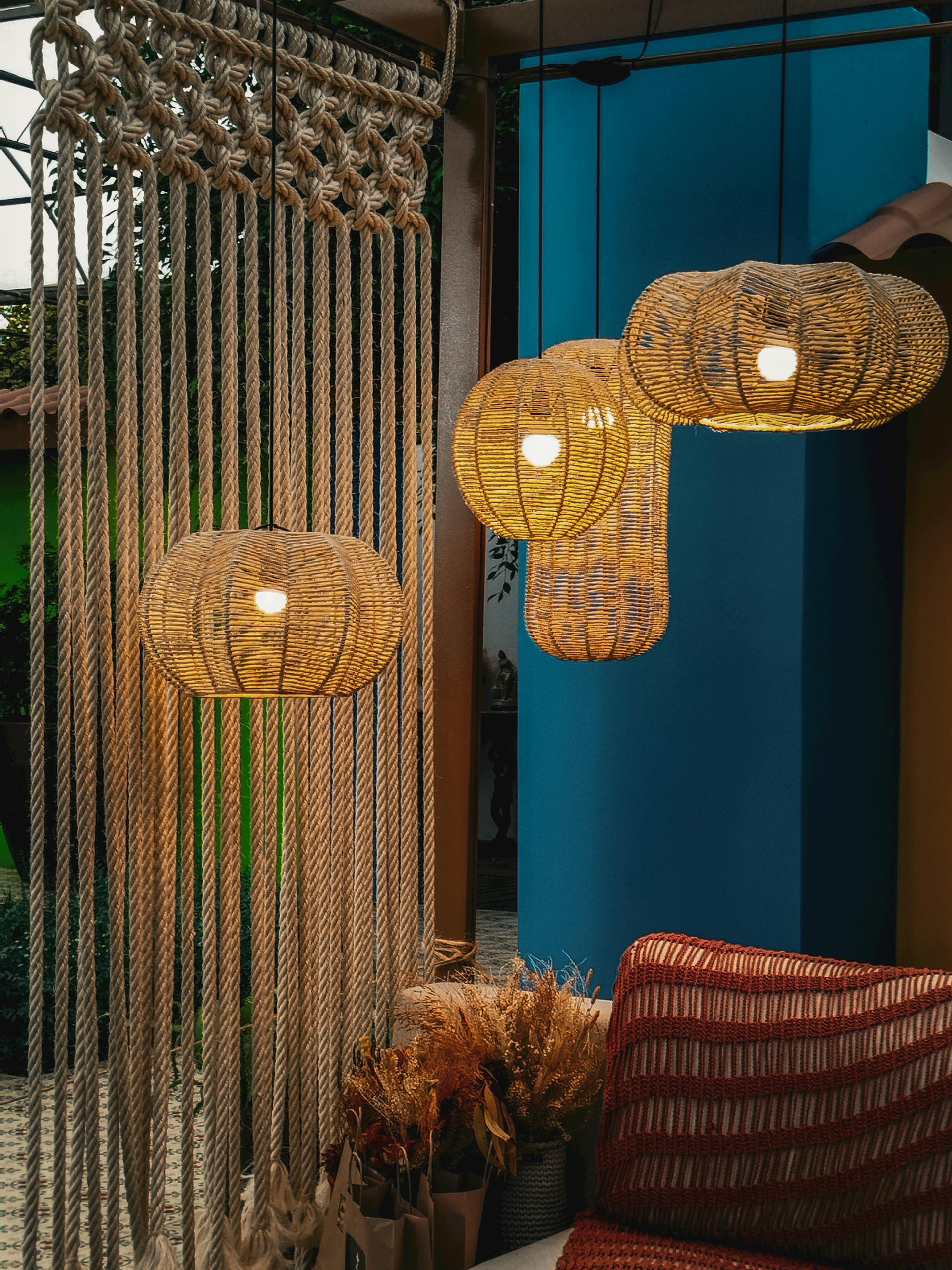 Overhead warm woven lights to give room an afrohemian vibe through decor.