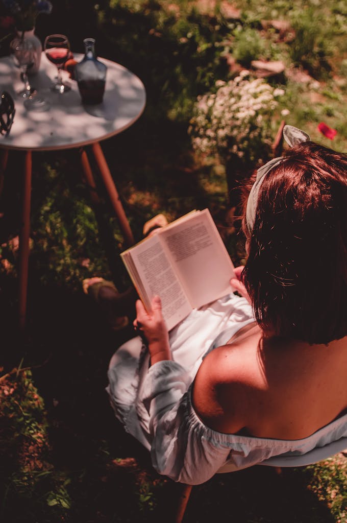 woman enjoying a solo summer night in at home with a book on a warm evening