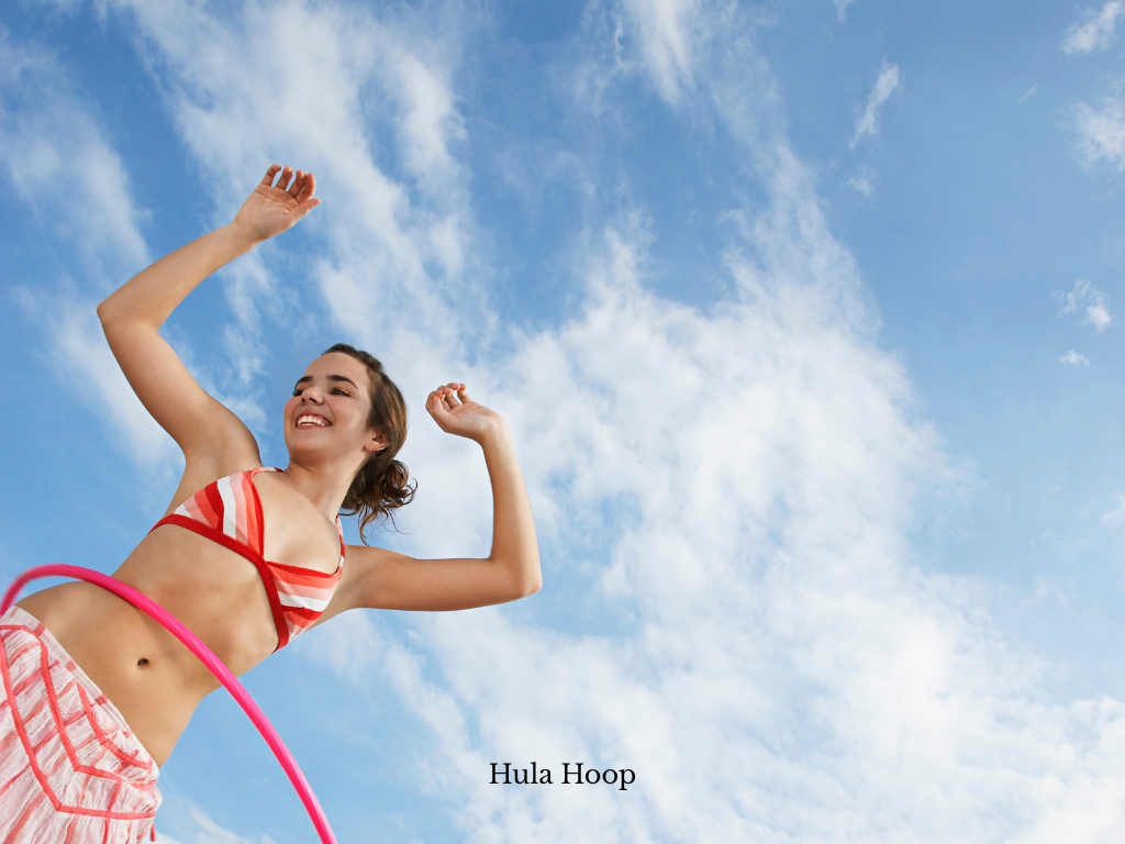 Woman Houla hooping in a bikini on a Playcation