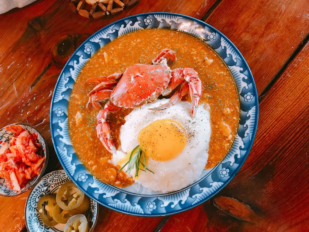 Delicious crab curry served with rice and a fried egg, shot in Jeju, South Korea.