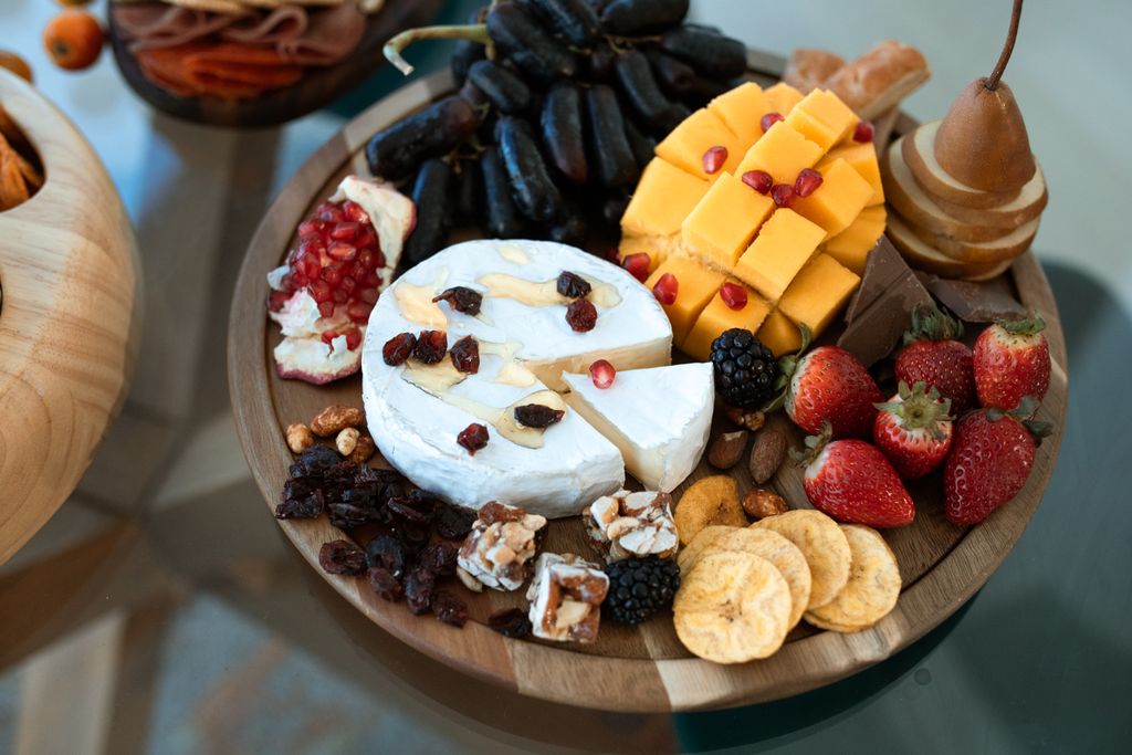 A stylish Grazing board with cheese, fruits, and nuts, perfect summer for entertaining.