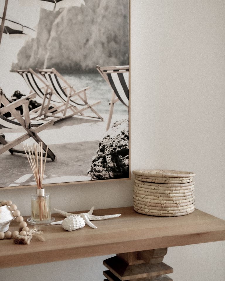 Elegant coastal-themed interior with a beach photo and stylish decor elements.