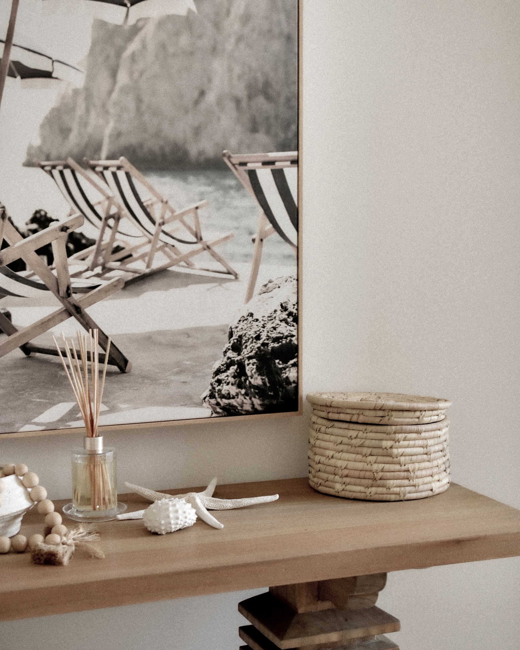 Elegant coastal-themed interior with a beach photo and stylish decor elements.