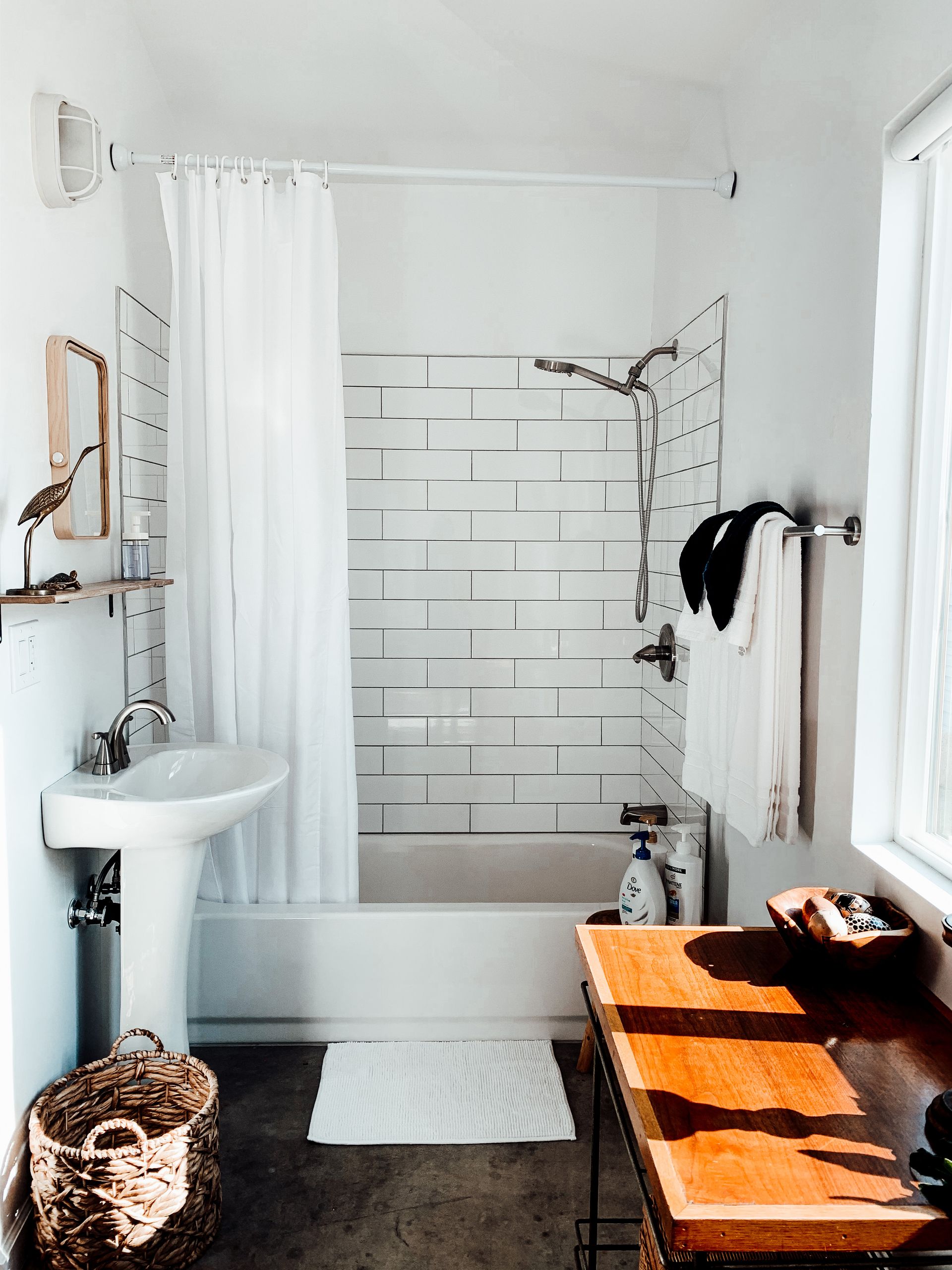 waffle texture shower curtain hanging in a clean simple bathroom in a newly moved into home — moving hacks to make your new home feel like a dream getaway