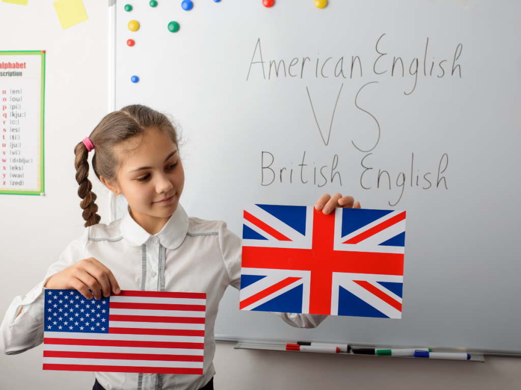 young girl showing UK flag and American flag with a board behind showing different spellings