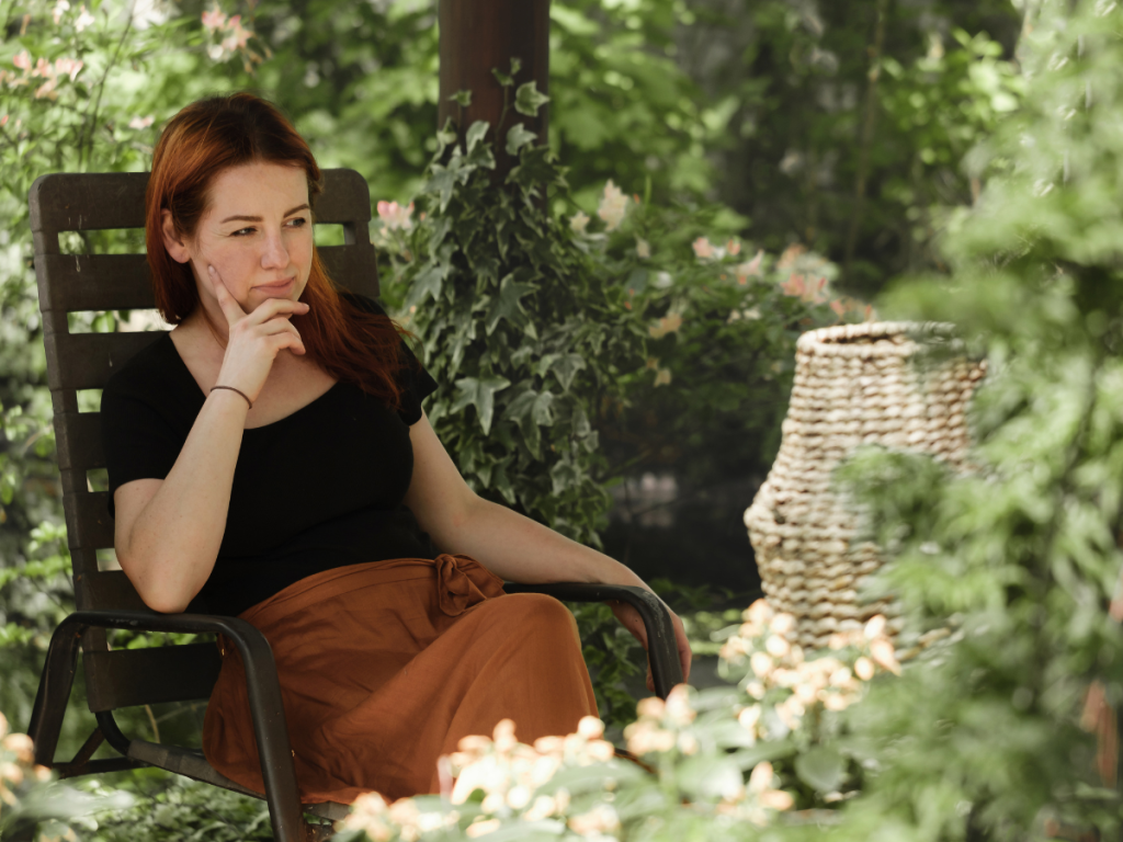 woman in a garden sitting doing nothing