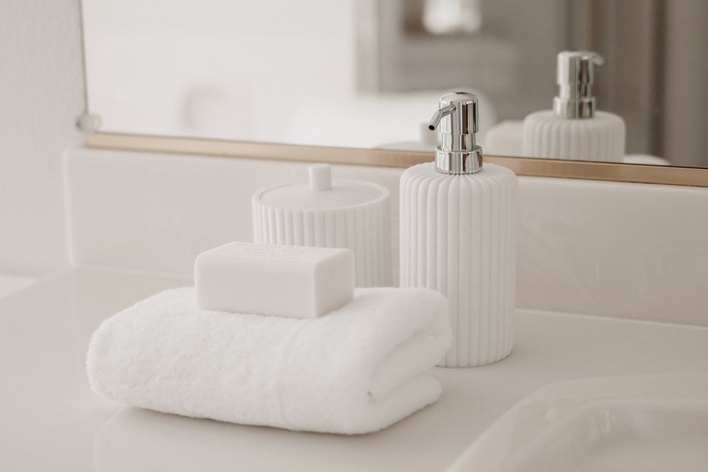 Stylish white soap bar and luxury towel arrangement in a modern hotel style  bathroom setting.