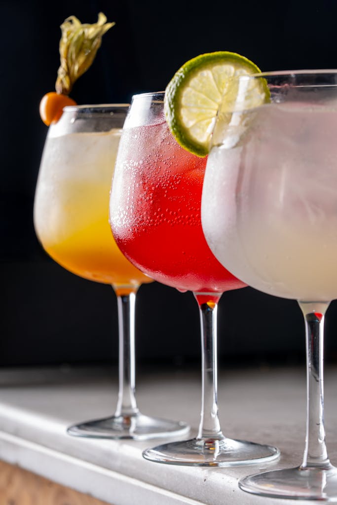 hree summer cocktails on a DIY home bar including a Hugo Spritz gin and tonic and strawberry daiquiri