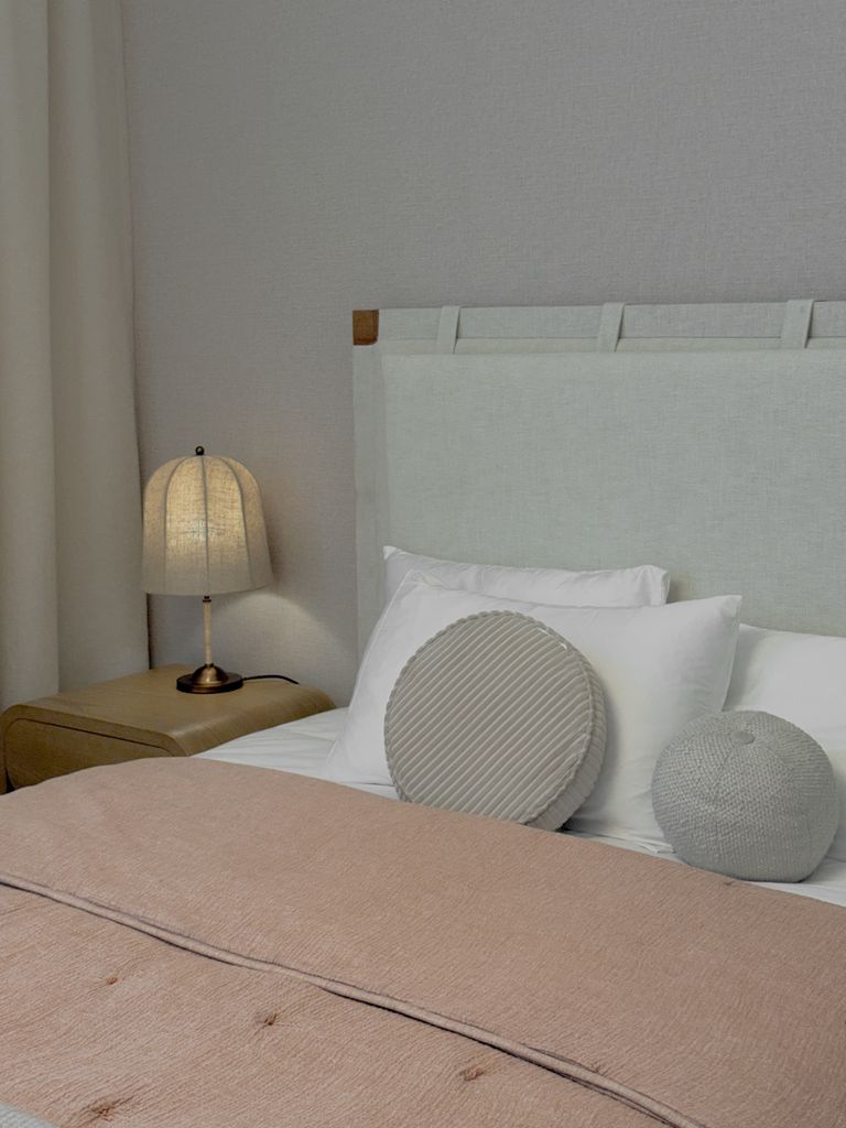 Elegant bedroom interior with neutral tones and cozy textiles.