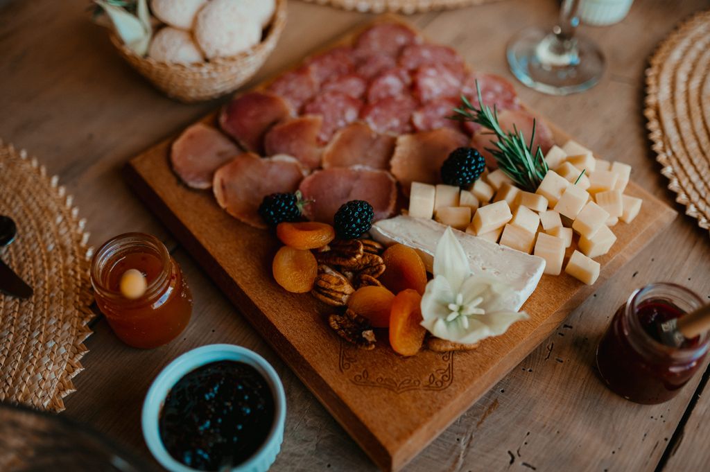 wooden serving board with cheese and fruit