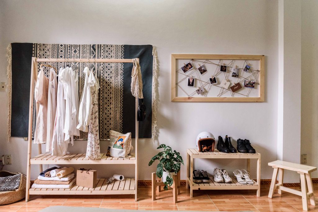 Stylish room with minimalist wardrobe and decor, showcasing clothing and shoes.