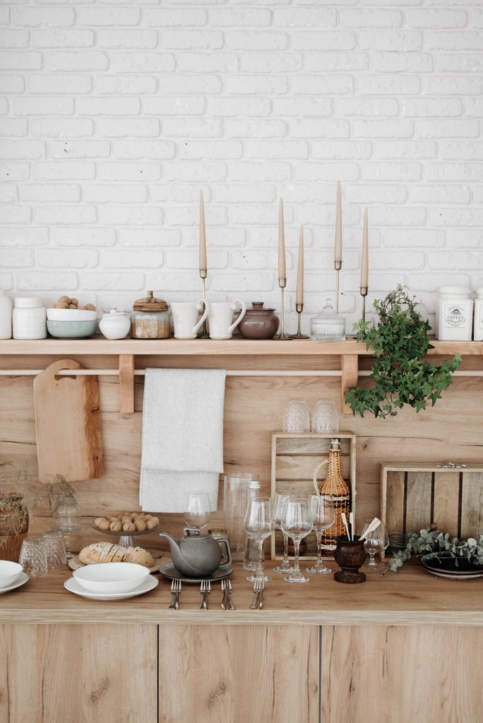 Stylish rustic kitchen with wooden accents and elegant kitchenware setup.